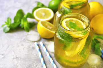 Homemade sparkling lemonade on a grey concrete,stone or slate ba