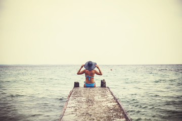 Naklejka premium Woman in blue bikini enjoying beach and summer sunny day