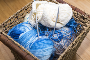 Wicker basket with three balls of wool