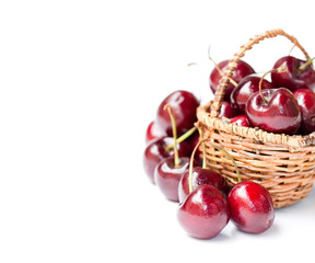 Cherries  in wicker basket isolated on white background