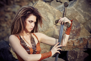 Beautiful girl in the clothes of a Viking or Amazon.