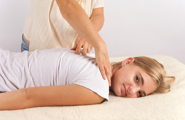 Obraz na płótnie Canvas Bowen masage therapy of a young woman