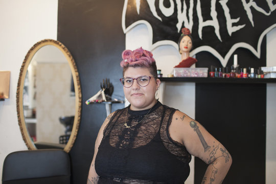 Portrait of beautician standing in salon