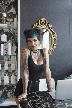 Portrait of female hair dresser standing in salon