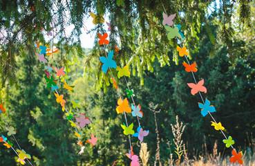 Decorations from paper butterflies on strings on a picnic.