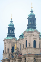 Fototapeta na wymiar Prague, Czechia - November, 21, 2016: St. Nicholas Church on Old Town Square in Prague, Czechia