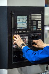 Operator hands on lcd screen of CNC machine