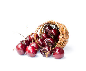 Cherries  in wicker basket isolated on white background