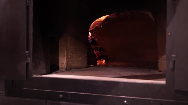 Image of a brick pizza oven with fire