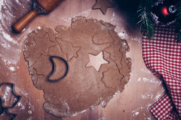 Cooking Christmas gingerbread cookies on a dark brown background