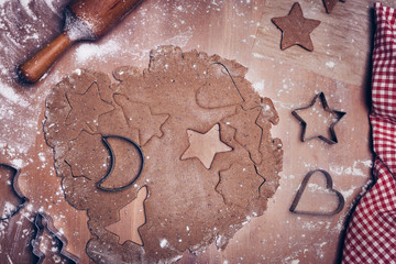 Cooking Christmas gingerbread cookies on a dark brown background