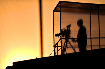Fototapeta na wymiar Cameraman's silhouette broadcasting