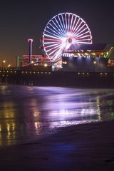 Santa Monica Beach Ferris wheel at night lit with the American Flag