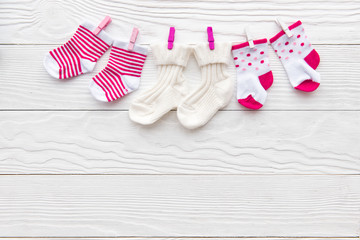 baby socks on rope at wooden background