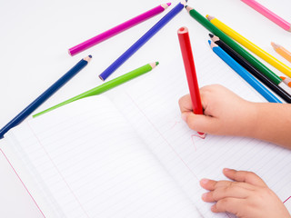 Girl draws with colored pencils