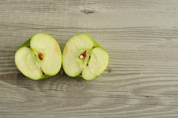 An apple that is sliced in two halves