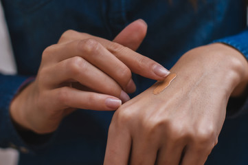 Obraz na płótnie Canvas Closeup of beautiful female hand applying hand cream