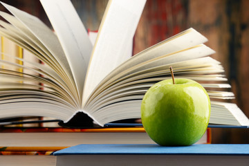 Composition with hardcover books and apple