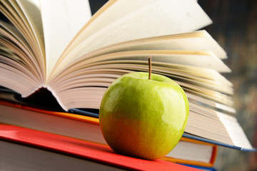 Composition with hardcover books and apple