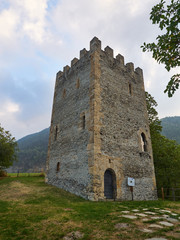 Oulx, Italy _ October  03, 2016 Medieval square crenellated tower called "Delfinale" or "Saracena" .