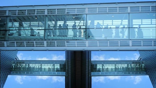 business people inside a modern glass building.