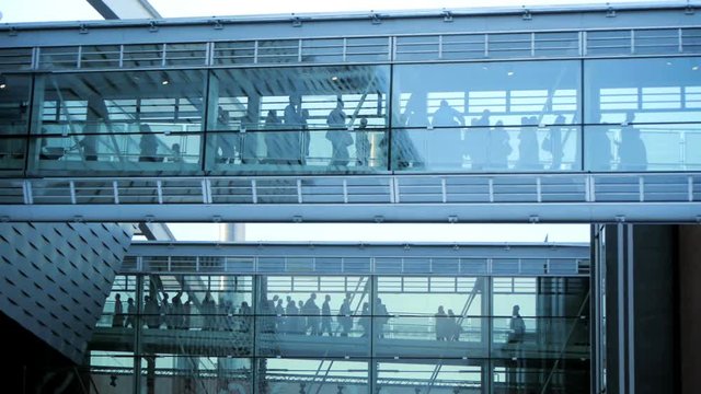 business people inside a modern glass building.