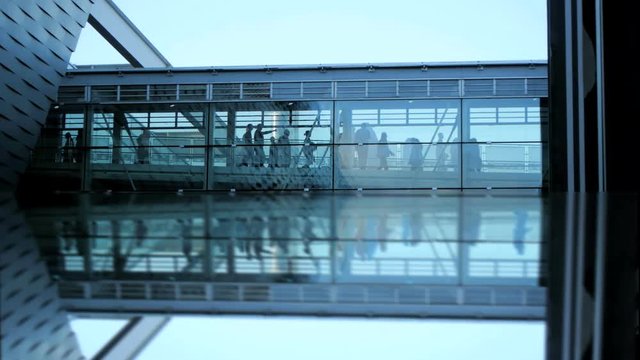business people inside a modern glass building.