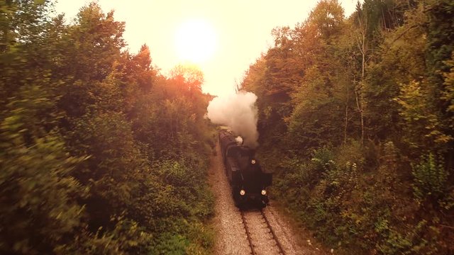 flying over nostalgic steam engine locomotive. retro vintage background.