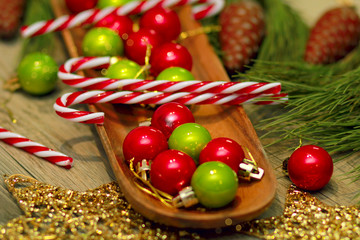 green and gold Christmas balls on wooden tray