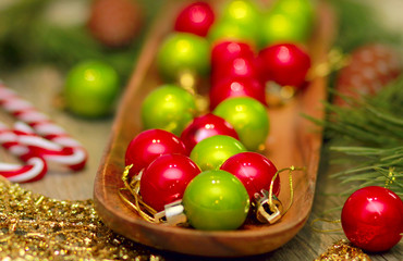 green and gold Christmas balls on wooden tray