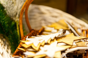 Christmas Fir Tree and stars Toys Old wooden in the basket Burning Candles, Boxes, Balls, Pine Cones, Walnuts, Branchesin the background other decorations and garlands.