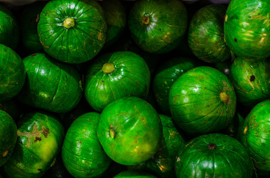 Fresh zapallito summer squash, traditional South American vegetable, on a market stall. Selective focus.