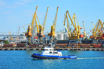 Fototapeta premium Tugboat and port cargo crane