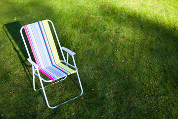 garden chair on green lawn background - Powered by Adobe