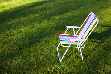 garden chair on green lawn background