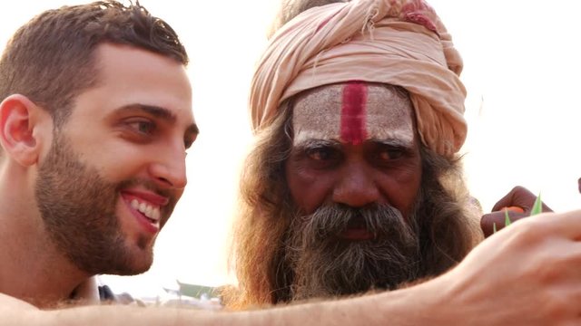 Tourist taking a selfie with Sadhu Holy Man in India