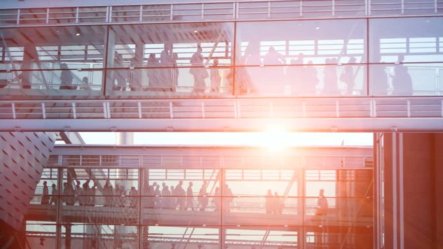 business people inside a modern glass building.