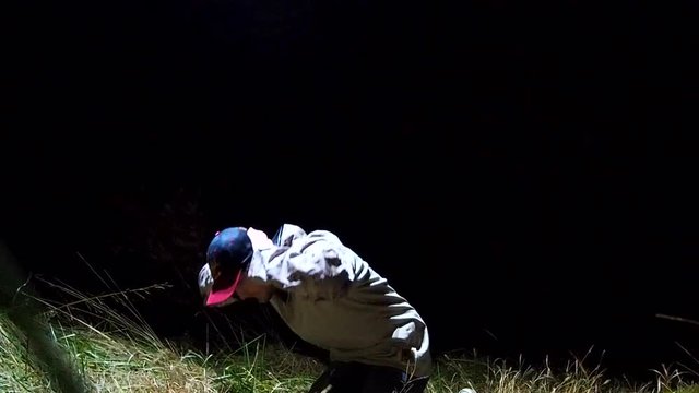 suspect being arrested by helicopter flying over head at night

