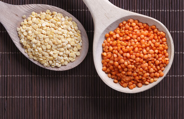 Red and yellow lentils in wooden spoon
