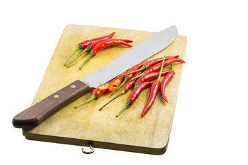 Knife and Red Chili on Wood Board