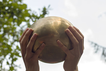hands rising a tibetan bowl