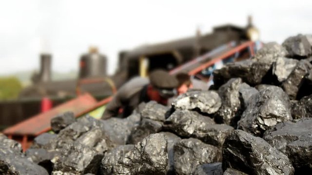 coal shoveling for steam engine locomotive train.