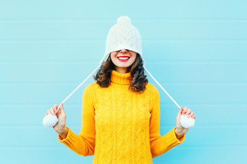 Fashion happy young woman in knitted hat and sweater having fun