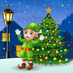 Christmas old elf with christmas tree and snowfall falling at night background 