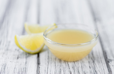 Wooden table with Lemon Juice (selective focus)