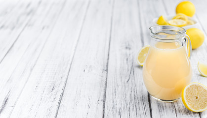 Wooden table with Lemon Juice (selective focus)