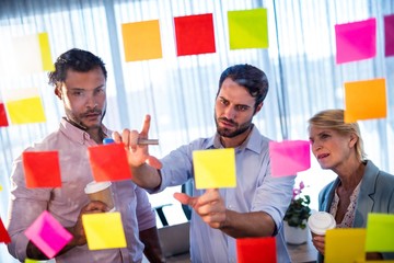Businessmen reading post it