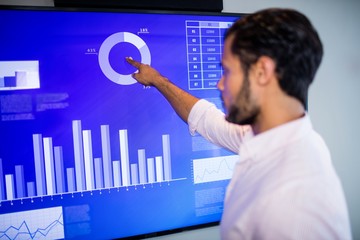 Side view of businessman using touch screen 
