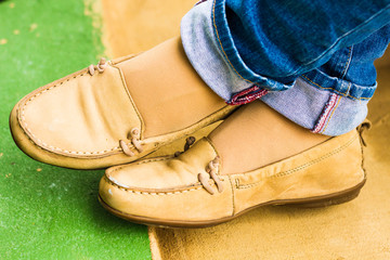 Close up of stylish female shoes. Outdoor fashion shoes footwear concept,Woman's legs in blue jeans.