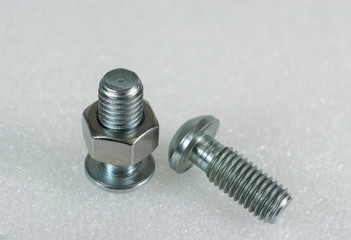 Two new bolts and nuts on white background